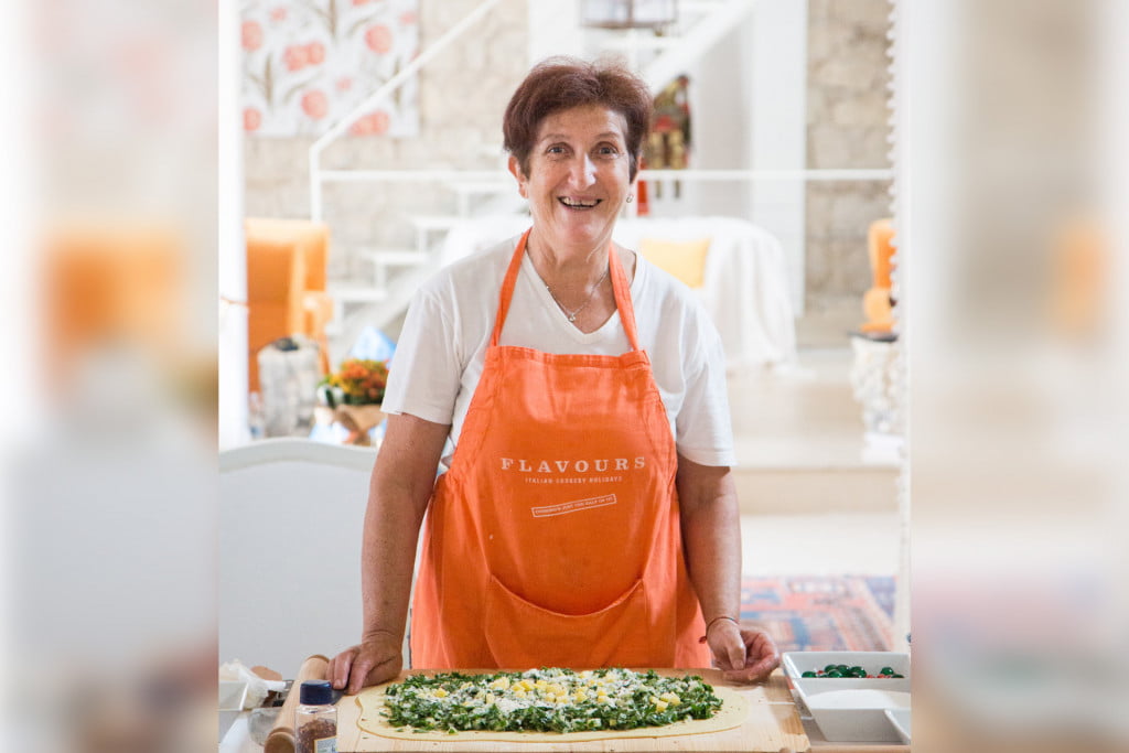 Sicilian chef in kitchen making pasta